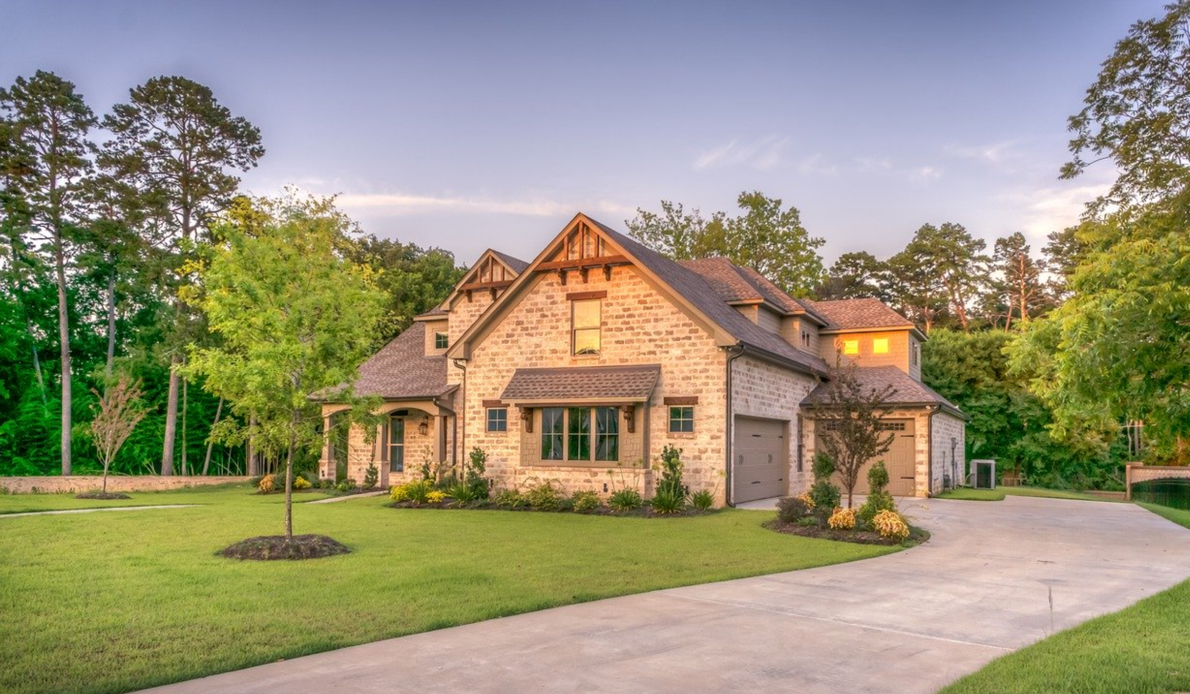 Beautiful multi-toned brick home with attached garage in the golden light of dusk on a real estate website for Travelers Rest real estate in upstate South Carolina.